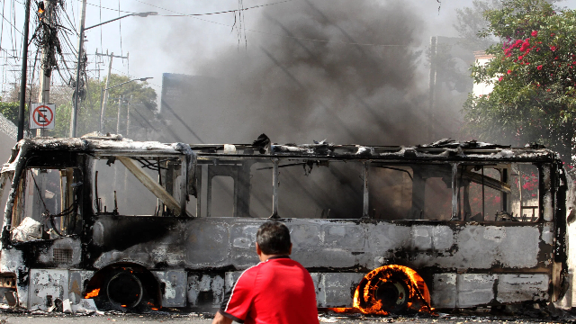 瓜达拉哈拉街头被焚烧的巴士 （来源：新华社图）